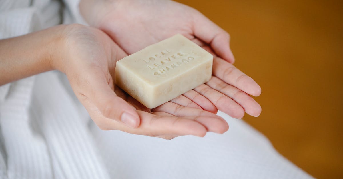 Can I still save my solid block of jam? - Crop anonymous female showing rectangular shaped dry ecological shampoo with title on blurred background Can I still save my solid block of jam? - Crop anonymous female showing rectangular shaped dry ecological shampoo with title on blurred background