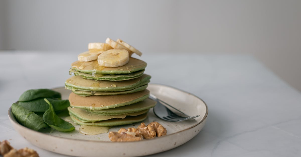 Can I substitute Molasses for Honey in Baking Recipes? - Gentle pancakes with syrup and fresh banana on top Can I substitute Molasses for Honey in Baking Recipes? - Gentle pancakes with syrup and fresh banana on top