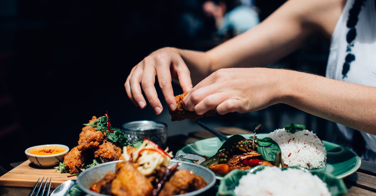 Can I use Basmati Rice for fried rice? - Person Holding Piece of Fried Chicken Above Plate with Food Can I use Basmati Rice for fried rice? - Person Holding Piece of Fried Chicken Above Plate with Food