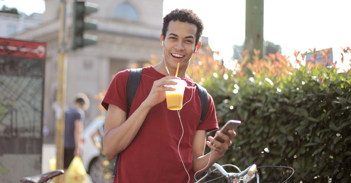 Can I use orange juice to pasteurize egg whites? - Happy young man using smartphone on street Can I use orange juice to pasteurize egg whites? - Happy young man using smartphone on street
