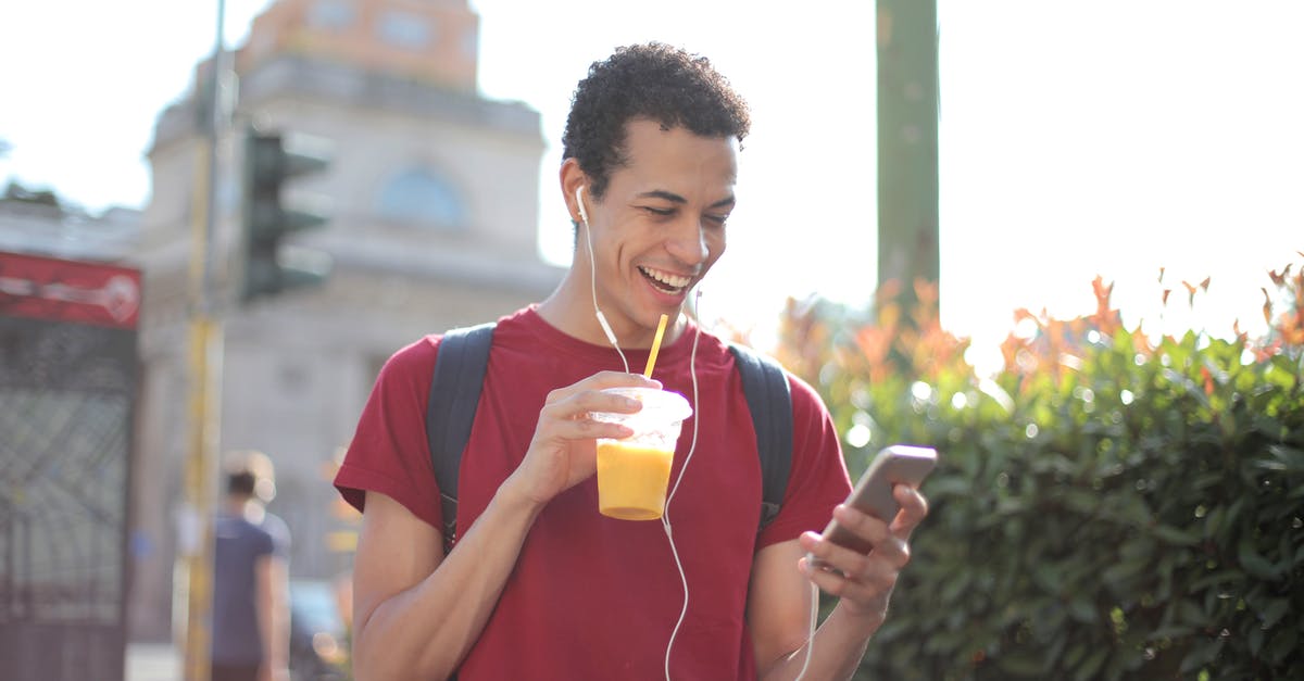 Can I use orange juice to pasteurize egg whites? - Happy ethnic guy in casual wear and with backpack having cup of fresh juice using smartphone while standing on street and listening to music Can I use orange juice to pasteurize egg whites? - Happy ethnic guy in casual wear and with backpack having cup of fresh juice using smartphone while standing on street and listening to music