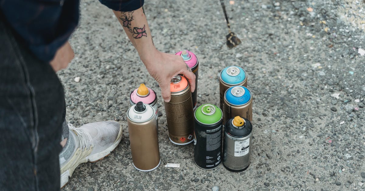 Can I weigh without a set of scales? - Crop faceless tattooed artist taking paint bottle from heap of multicolored spray cans placed on ground on street of city Can I weigh without a set of scales? - Crop faceless tattooed artist taking paint bottle from heap of multicolored spray cans placed on ground on street of city