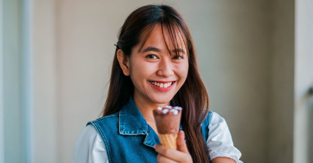 Can Ice Cream Maker Wall be Too Cold? - Smiling Asian woman with chocolate ice cream Can Ice Cream Maker Wall be Too Cold? - Smiling Asian woman with chocolate ice cream