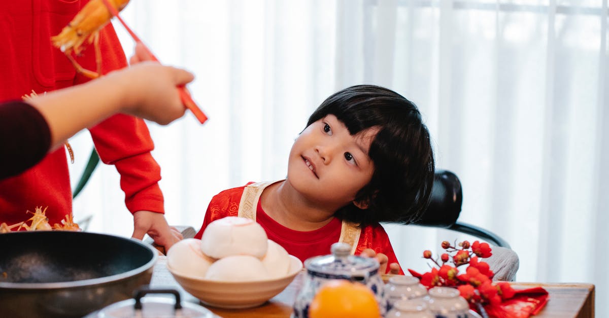 Can jasmine rice and basmati rice be cooked together? - Crop unrecognizable person with tasty prawn against ethnic child and relative at table during New Year holiday Can jasmine rice and basmati rice be cooked together? - Crop unrecognizable person with tasty prawn against ethnic child and relative at table during New Year holiday