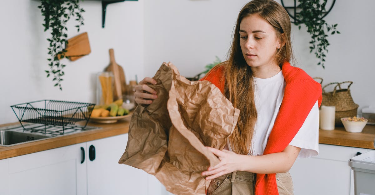 Can lemon juice concentrate be used after the use-by-date? - Young serious female with long hair sorting reusable paper trash in modern kitchen in apartment Can lemon juice concentrate be used after the use-by-date? - Young serious female with long hair sorting reusable paper trash in modern kitchen in apartment
