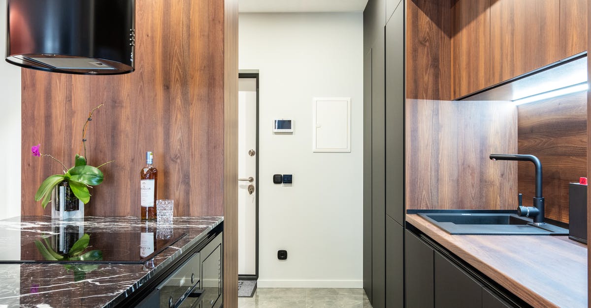 Can microwave safe glass vessels be used in an electric oven? - Modern kitchen with hob built in table with flower and bottle of liquor against tap in house Can microwave safe glass vessels be used in an electric oven? - Modern kitchen with hob built in table with flower and bottle of liquor against tap in house