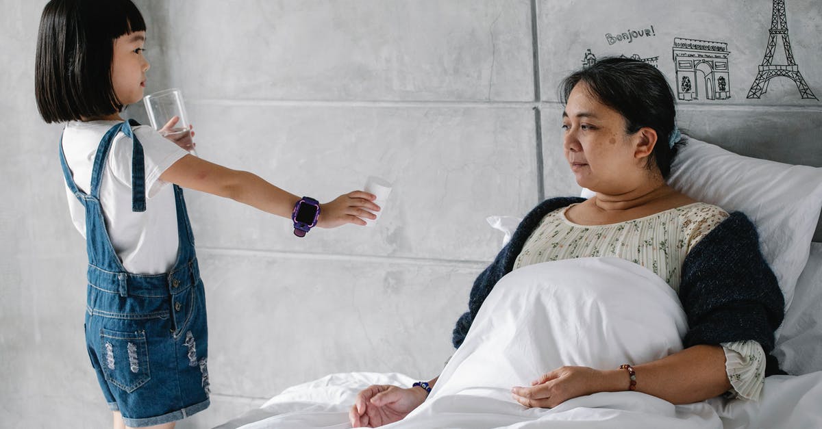 Can one get sick from drinking too much home made Water Kefir? [closed] - Side view of adorable little Asian girl giving medicine and water to sick grandmother sitting in bed