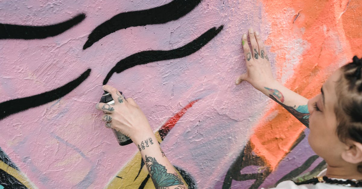 Can one tell from the outside whether a papaya has seeds? - Ethnic woman spraying paint on wall