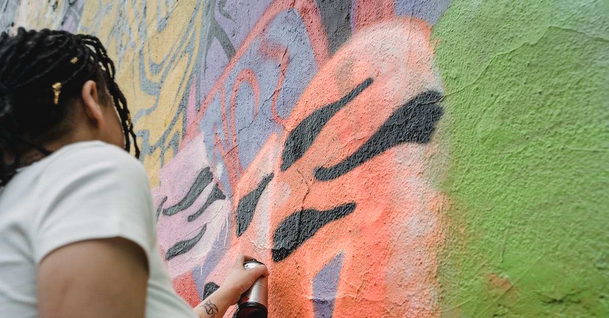 Can one tell from the outside whether a papaya has seeds? - From below side view of anonymous female artist in casual wear and black braided hair painting graffiti on colorful wall Can one tell from the outside whether a papaya has seeds? - From below side view of anonymous female artist in casual wear and black braided hair painting graffiti on colorful wall