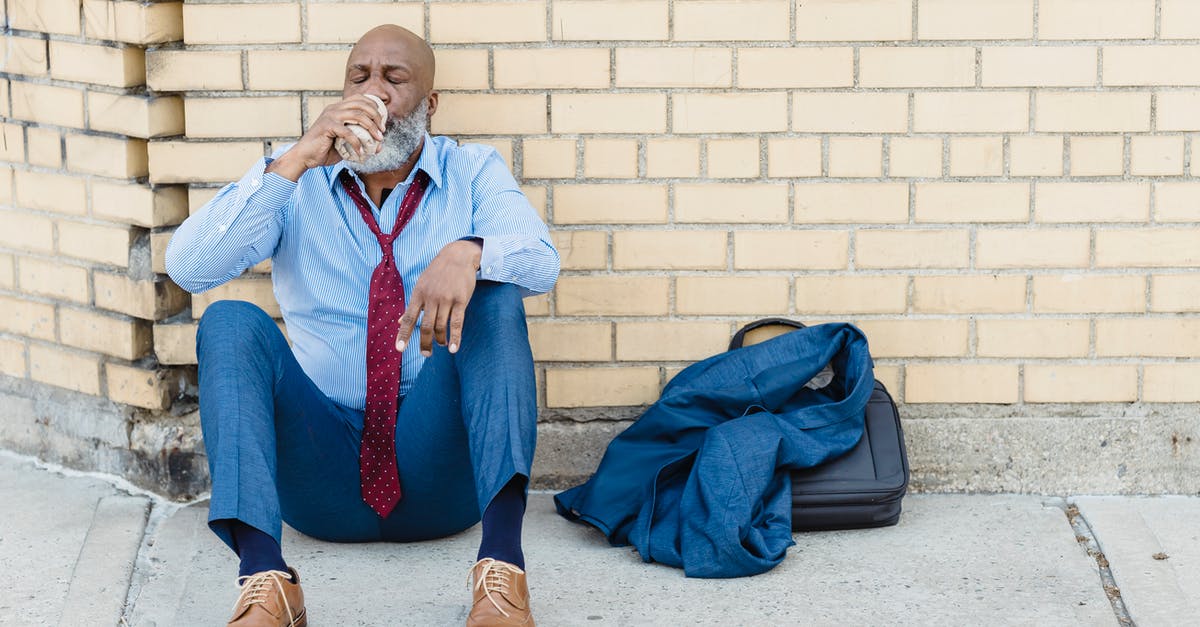 Can Southern Blue Whiting replace Cod? - Full body of mature African American bearded businessman in blue trousers and light shirt with maroon tie sitting on ground at brick wall and drinking beverage from tin can Can Southern Blue Whiting replace Cod? - Full body of mature African American bearded businessman in blue trousers and light shirt with maroon tie sitting on ground at brick wall and drinking beverage from tin can