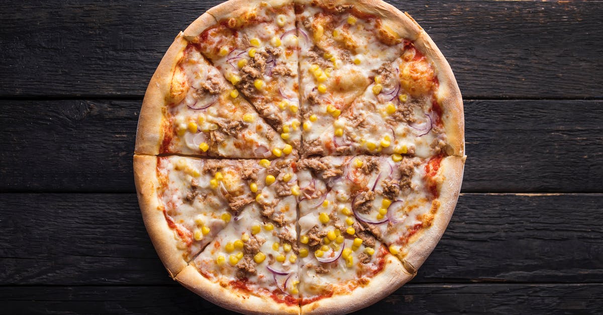 Can thawing meat too quickly affect its quality? - Tasty pizza with canned corn grains on wooden surface Can thawing meat too quickly affect its quality? - Tasty pizza with canned corn grains on wooden surface