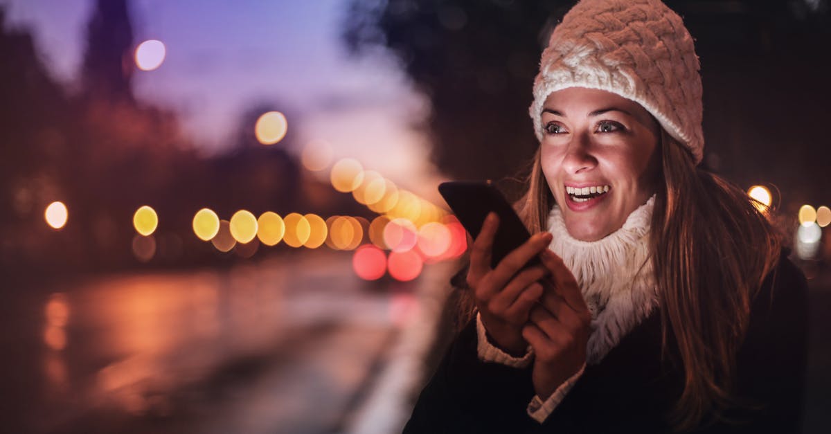 Can you make goulash using winter squash instead of cabbage? - Cheerful woman recording voice message on smartphone in street Can you make goulash using winter squash instead of cabbage? - Cheerful woman recording voice message on smartphone in street