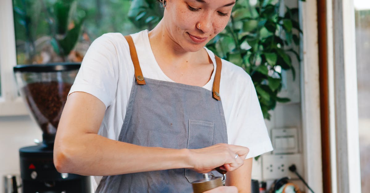 can you make marmalade using sous vide? - Crop happy female in apron smiling and using grinder for preparing aromatic coffee in kitchen can you make marmalade using sous vide? - Crop happy female in apron smiling and using grinder for preparing aromatic coffee in kitchen