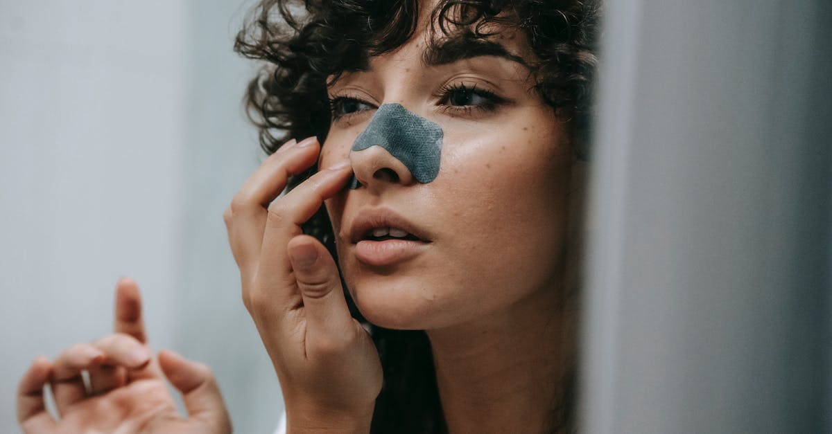 Can you peel a soft boiled egg? - Mirror reflection of young female with curly hair putting nose strip mask on face in bathroom Can you peel a soft boiled egg? - Mirror reflection of young female with curly hair putting nose strip mask on face in bathroom