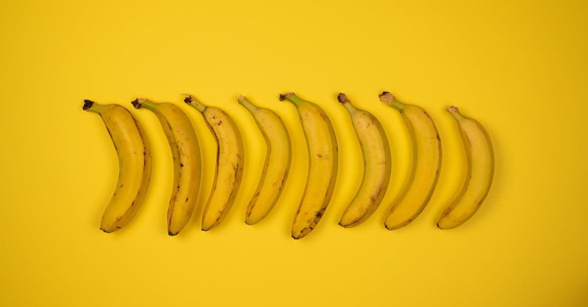 Can you peel a soft boiled egg? - Top view of tasty ripe bananas with blots on peel composed in row on yellow background Can you peel a soft boiled egg? - Top view of tasty ripe bananas with blots on peel composed in row on yellow background