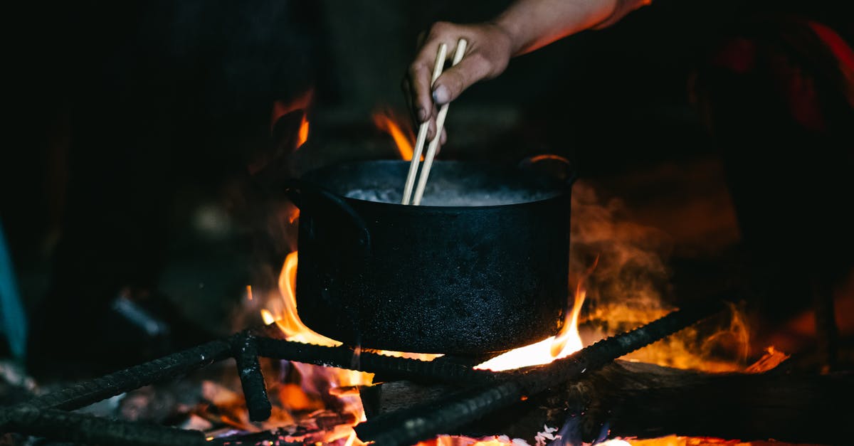 Caramel without stirring or burning - Person Holding Black Pot With Fire Caramel without stirring or burning - Person Holding Black Pot With Fire