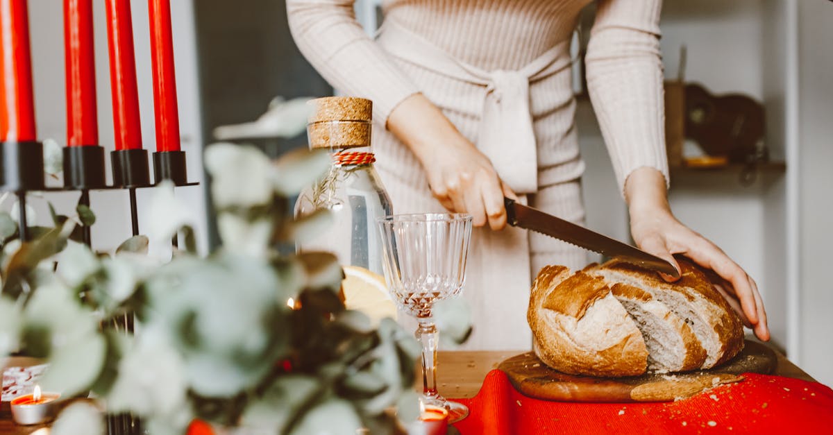 Care and warping of wooden chopping board - A Woman Slicing a Loaf of Bread on a Chopping Board Care and warping of wooden chopping board - A Woman Slicing a Loaf of Bread on a Chopping Board
