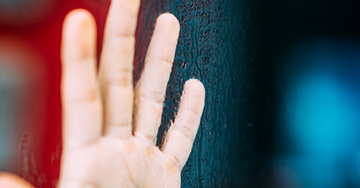 Carrots turning dark at heads, and on skin after chopping? - Crop unrecognizable person showing raised hand with calluses illuminated by colorful light near tree trunk Carrots turning dark at heads, and on skin after chopping? - Crop unrecognizable person showing raised hand with calluses illuminated by colorful light near tree trunk