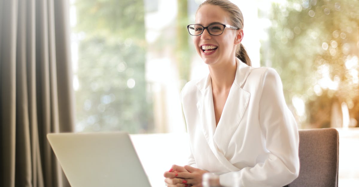 Casein content after curdling - Laughing businesswoman working in office with laptop Casein content after curdling - Laughing businesswoman working in office with laptop