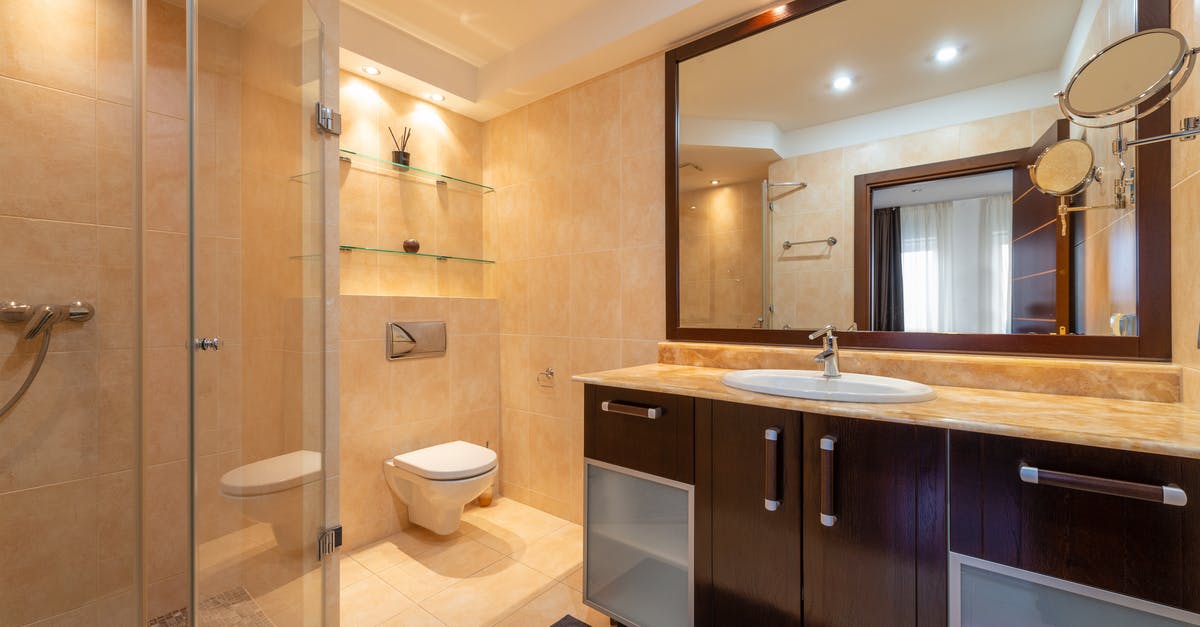 Ceramic non stick pan, light scratches after first use? - Shower room against toilet bowl and cabinet with washbasin under mirrors illuminated by shiny lamps in modern house Ceramic non stick pan, light scratches after first use? - Shower room against toilet bowl and cabinet with washbasin under mirrors illuminated by shiny lamps in modern house