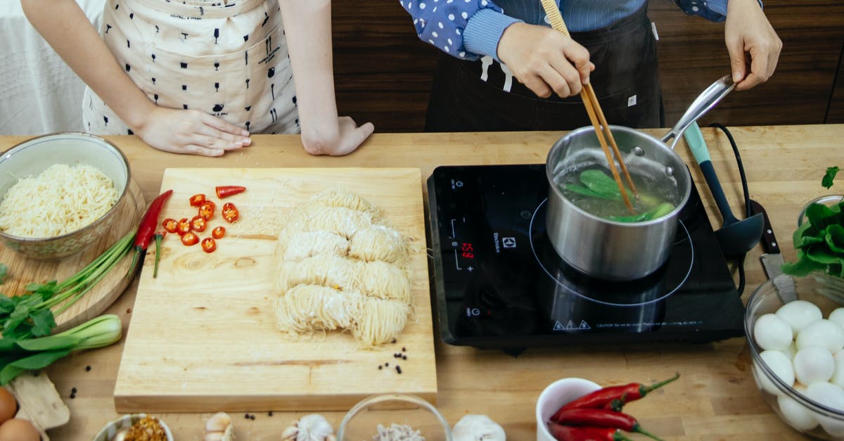 Cheese that Pairs with Spicy Food - High angle of unrecognizable women boiling greens in saucepan making noodles with spices Cheese that Pairs with Spicy Food - High angle of unrecognizable women boiling greens in saucepan making noodles with spices