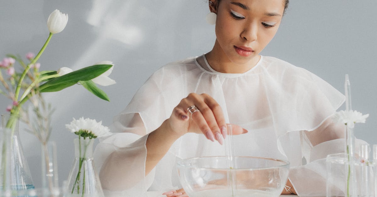 Chemistry of making carbonated water? - Woman in White Making Table Arrangement Looking Like Science Laboratory Chemistry of making carbonated water? - Woman in White Making Table Arrangement Looking Like Science Laboratory