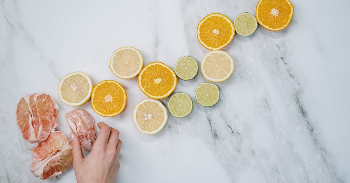 Chinese cooking troubleshooting: still biting into pieces of ginger - Sliced Orange Fruits on White Table Chinese cooking troubleshooting: still biting into pieces of ginger - Sliced Orange Fruits on White Table
