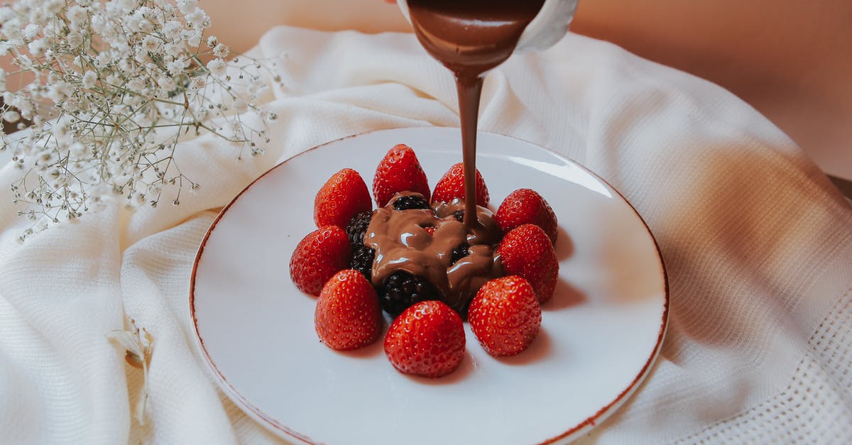 Chocolate ganache - Pouring of Chocolate Ganache on Berries Chocolate ganache - Pouring of Chocolate Ganache on Berries
