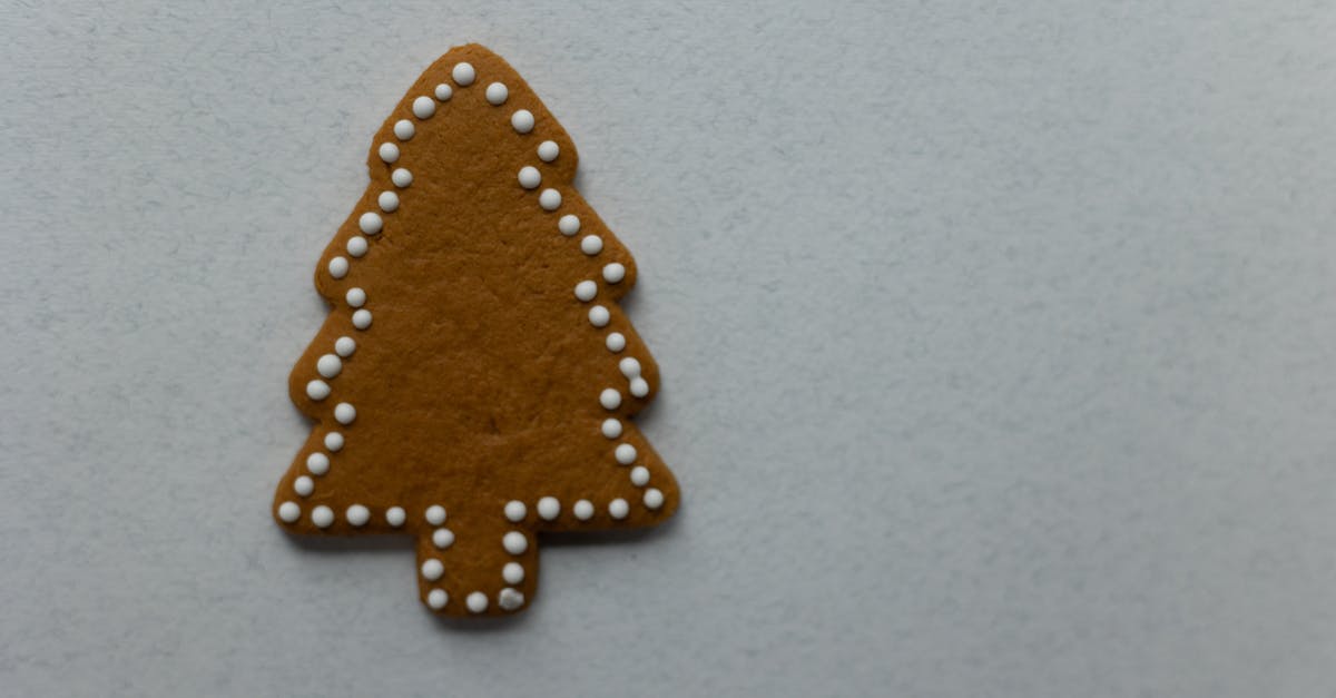 Cinnamon is discoloring my icing - Tree shaped gingerbread placed on white background Cinnamon is discoloring my icing - Tree shaped gingerbread placed on white background