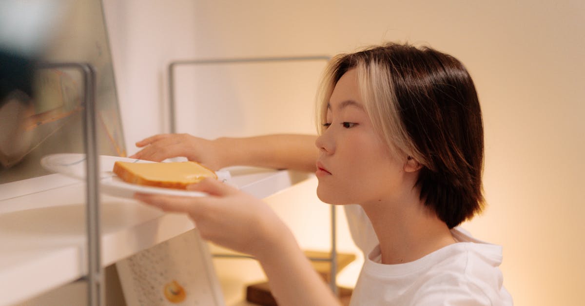 Cleaning a food processor - Woman in White Shirt Cleaning the Book Shelves Cleaning a food processor - Woman in White Shirt Cleaning the Book Shelves
