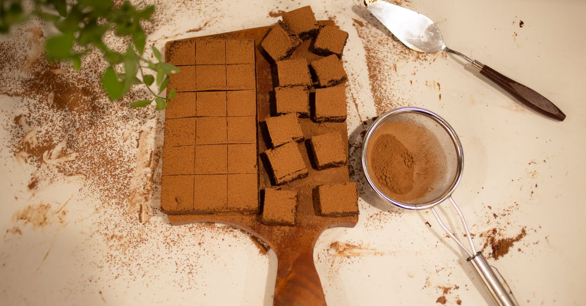 Cocoa nibs used for cooking or baking? - Chocolate Brownie with Cocoa Powder on White Table Cocoa nibs used for cooking or baking? - Chocolate Brownie with Cocoa Powder on White Table