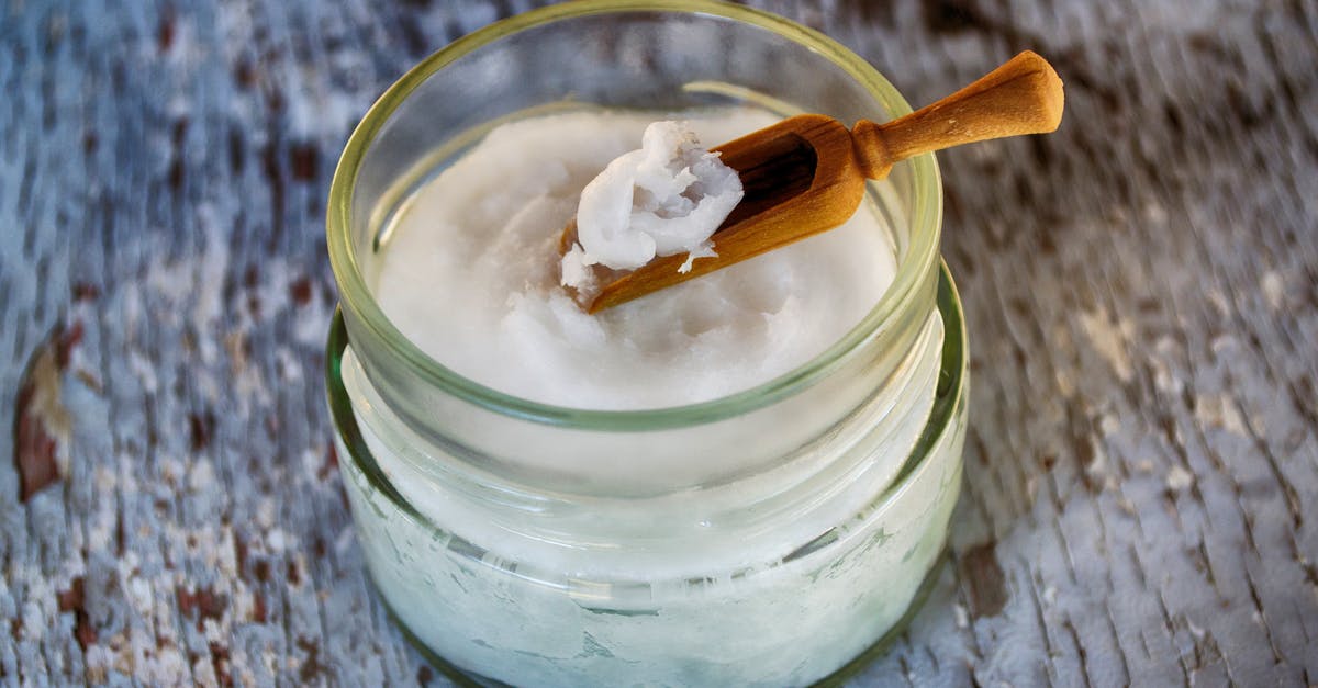 Coconut cream from coconut butter - Clear Glass Container with Coconut Oil Coconut cream from coconut butter - Clear Glass Container with Coconut Oil