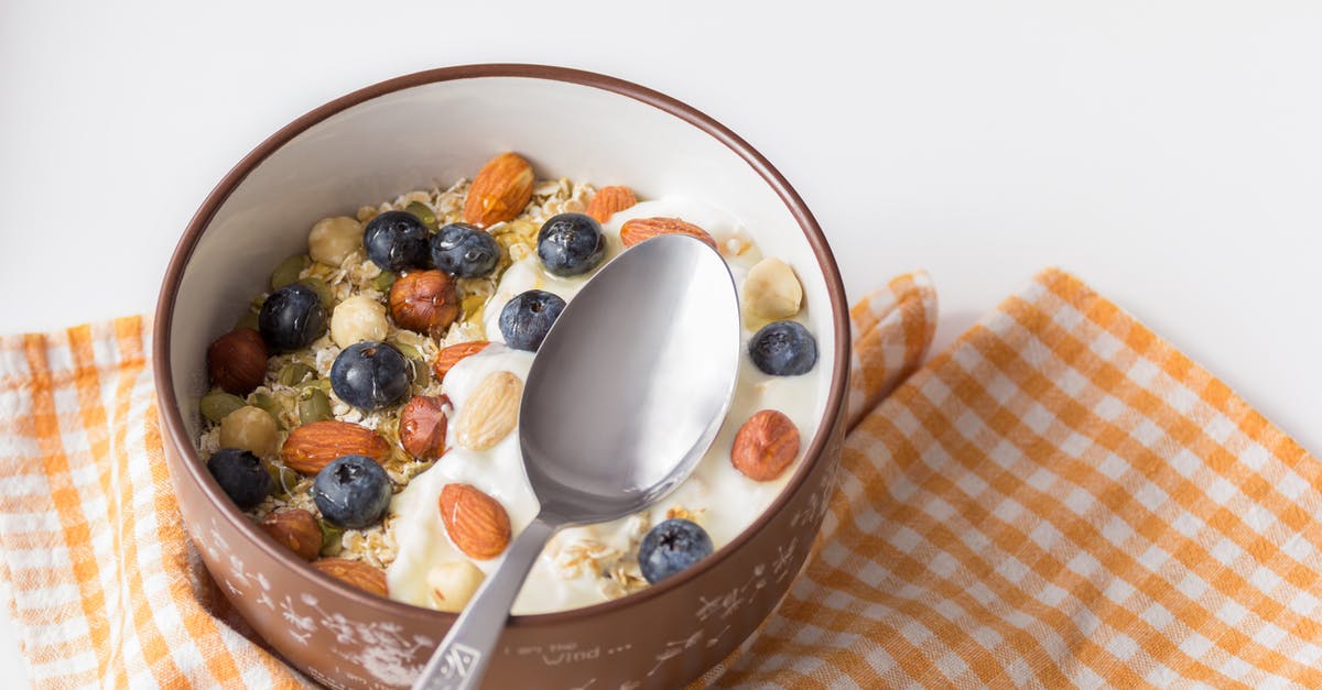 Coconut yoghurt too thick - Stainless Steel Spoon on Brown Ceramic Bowl Coconut yoghurt too thick - Stainless Steel Spoon on Brown Ceramic Bowl