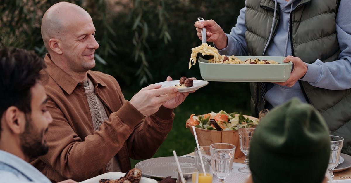 Cold / cooked pasta safe to eat? - Unrecognizable woman serving delicious pasta with meatballs to man during dinner Cold / cooked pasta safe to eat? - Unrecognizable woman serving delicious pasta with meatballs to man during dinner