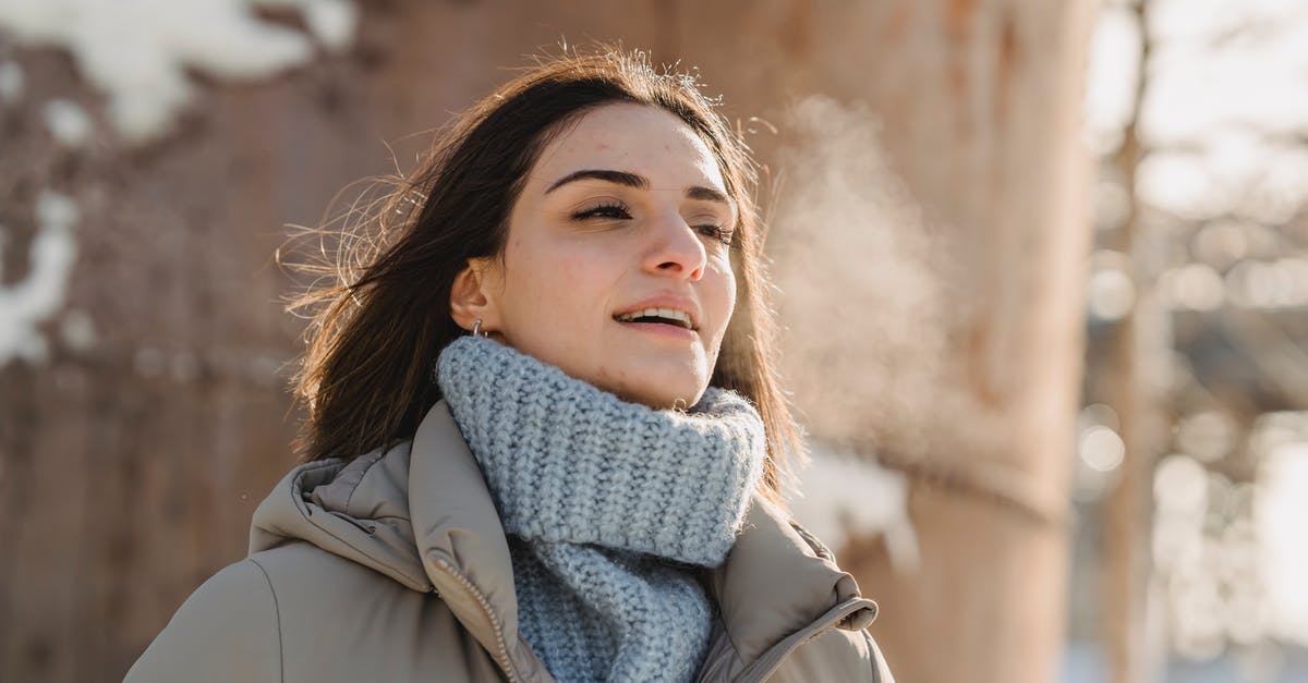 Cold Smoking in the Tropics - Condensation - Young woman exhaling steam on freezing cold weather Cold Smoking in the Tropics - Condensation - Young woman exhaling steam on freezing cold weather