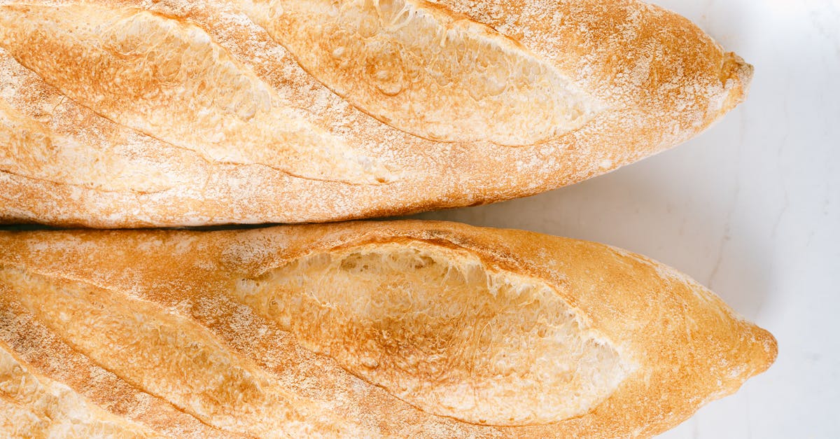 Commercial part-baked baguettes - Baguettes Bread on White Surface Commercial part-baked baguettes - Baguettes Bread on White Surface