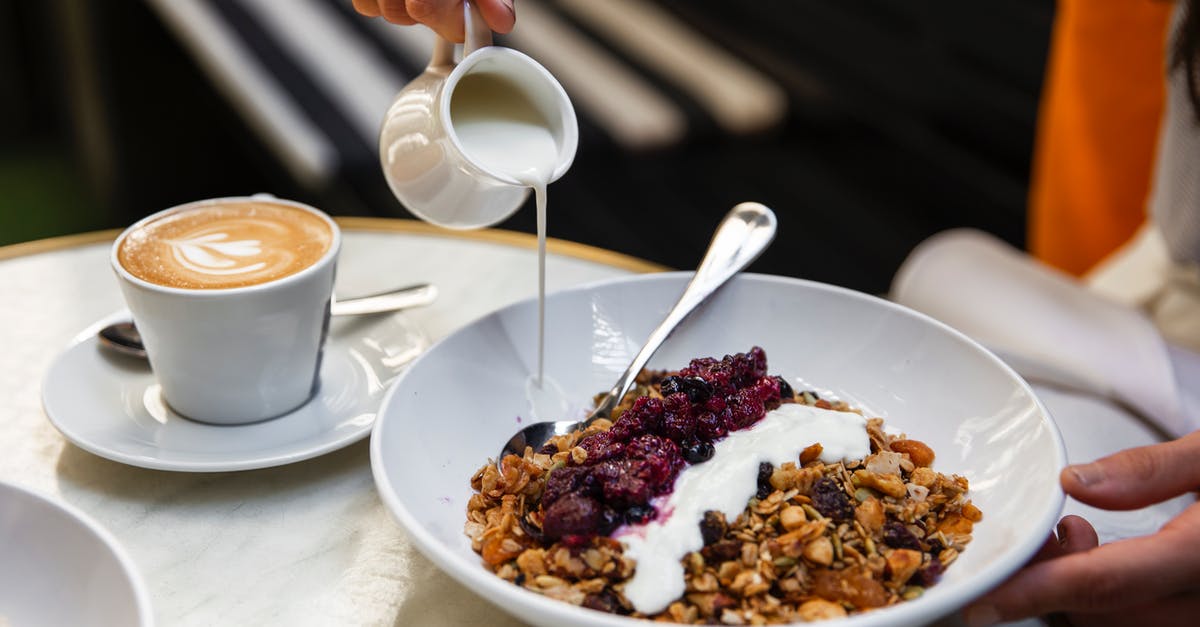 Condensed milk doesn't mix well into iced coffee - Unrecognizable person having breakfast at table with coffee and muesli