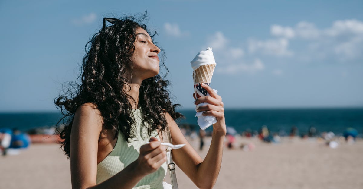Contamination implications of eating peanut butter with a spoon - Woman Eating Vanilla Ice Cream Contamination implications of eating peanut butter with a spoon - Woman Eating Vanilla Ice Cream