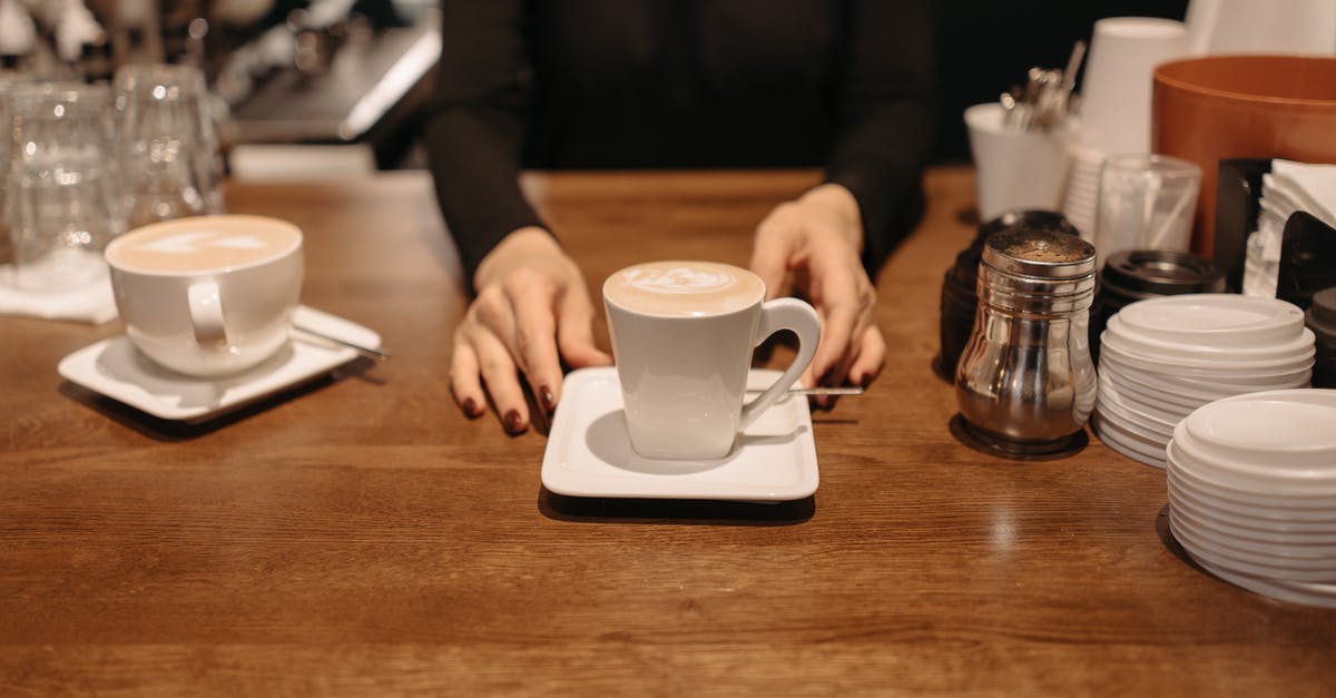 converting cups of rice to kilos - Person Holding White Ceramic Mug on Brown Wooden Table converting cups of rice to kilos - Person Holding White Ceramic Mug on Brown Wooden Table