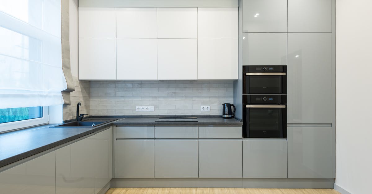 Converting oven recipe to slow cooker - Interior of contemporary kitchen with gray and white cabinets with sink and modern oven near electric cooker in spacious apartment Converting oven recipe to slow cooker - Interior of contemporary kitchen with gray and white cabinets with sink and modern oven near electric cooker in spacious apartment
