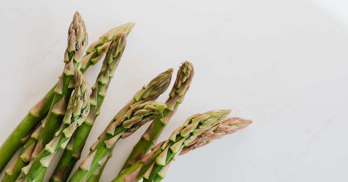 Cooked white asparagus is stringy - Fresh ripe asparagus pods in bunch Cooked white asparagus is stringy - Fresh ripe asparagus pods in bunch