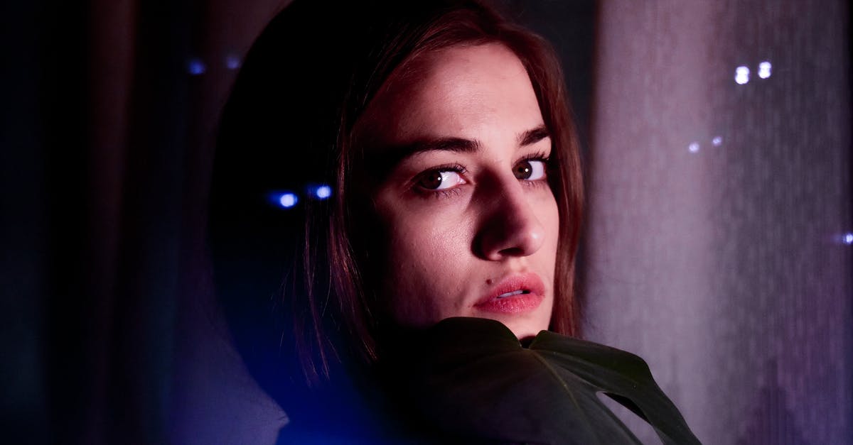 Cookies are soft in the middle, even though the edges are browned - Young female in gloves with deep gaze and mole looking at camera in evening lights