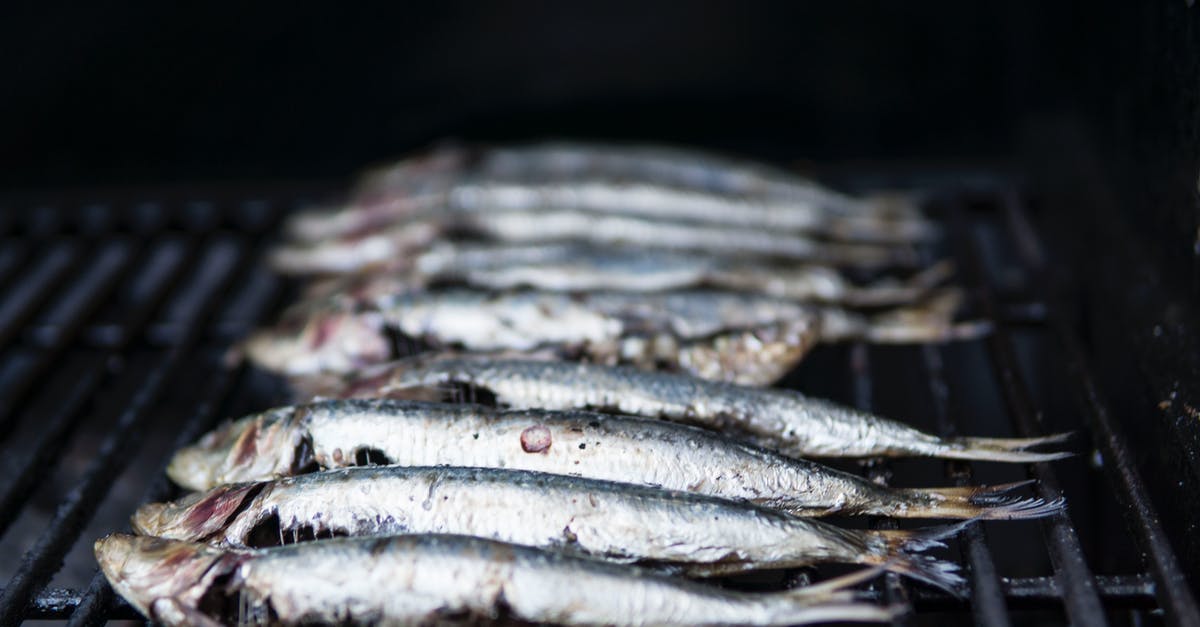Cooking a mix of raw and cooked meat - Photo of Raw Fish on Grill Cooking a mix of raw and cooked meat - Photo of Raw Fish on Grill