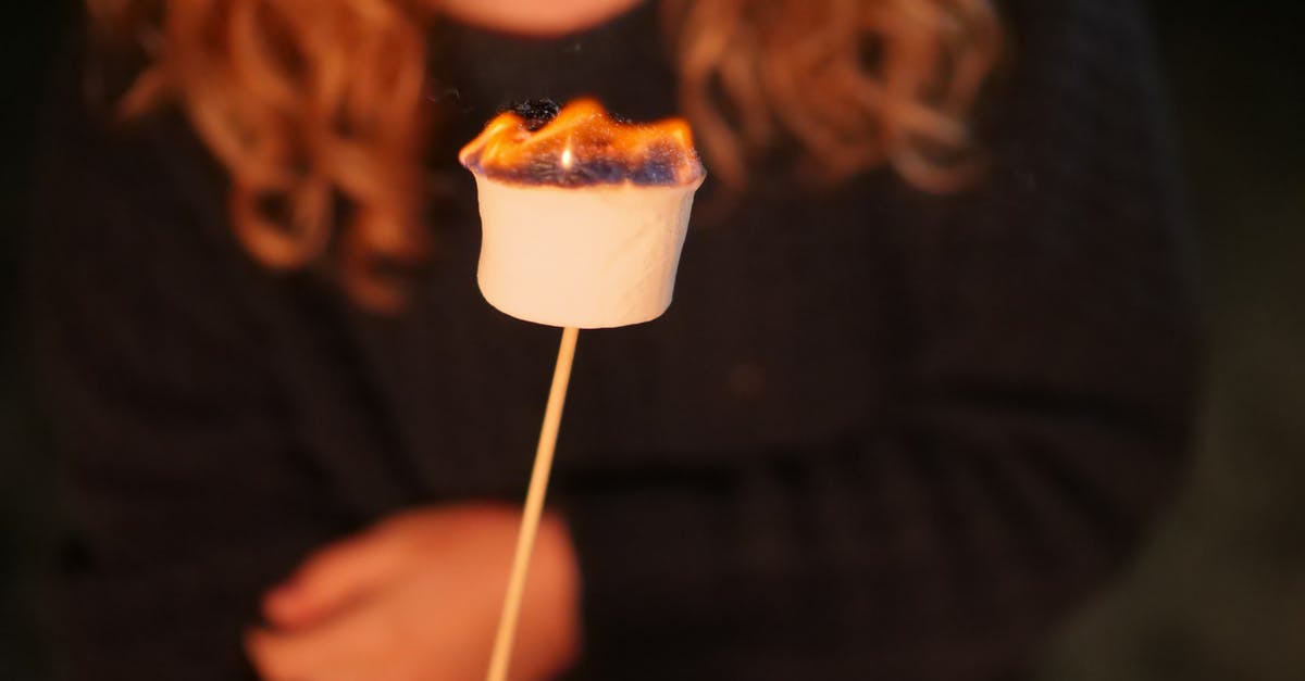 Cooking English Muffins Without Burning - Person Holding Marshmallow on Stick with Fire Cooking English Muffins Without Burning - Person Holding Marshmallow on Stick with Fire