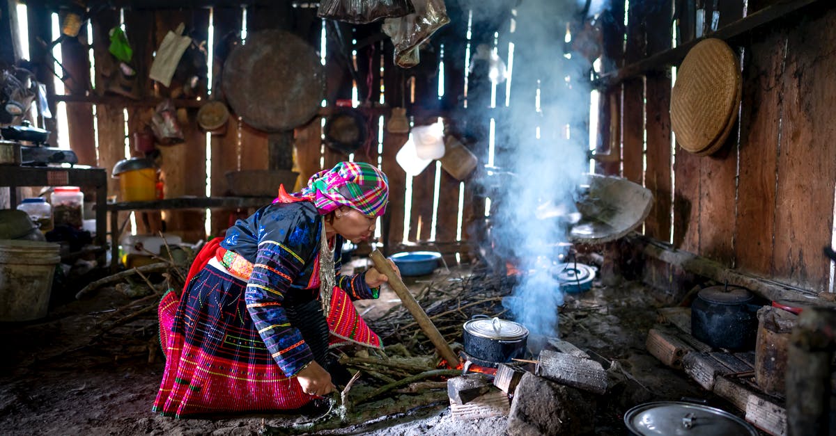 Cooking octopus: simple boil or broth? - Focused woman cooking on fire Cooking octopus: simple boil or broth? - Focused woman cooking on fire