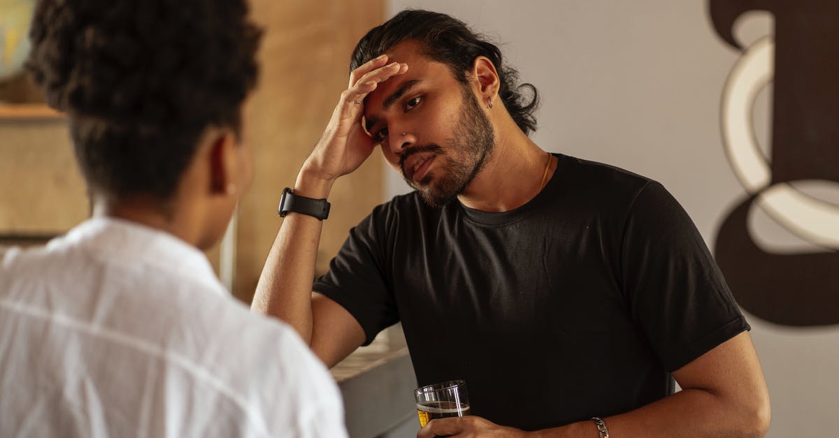 Cooking one-handed: things to watch out for - Man in Black Crew Neck T-shirt Holding Clear Drinking Glass