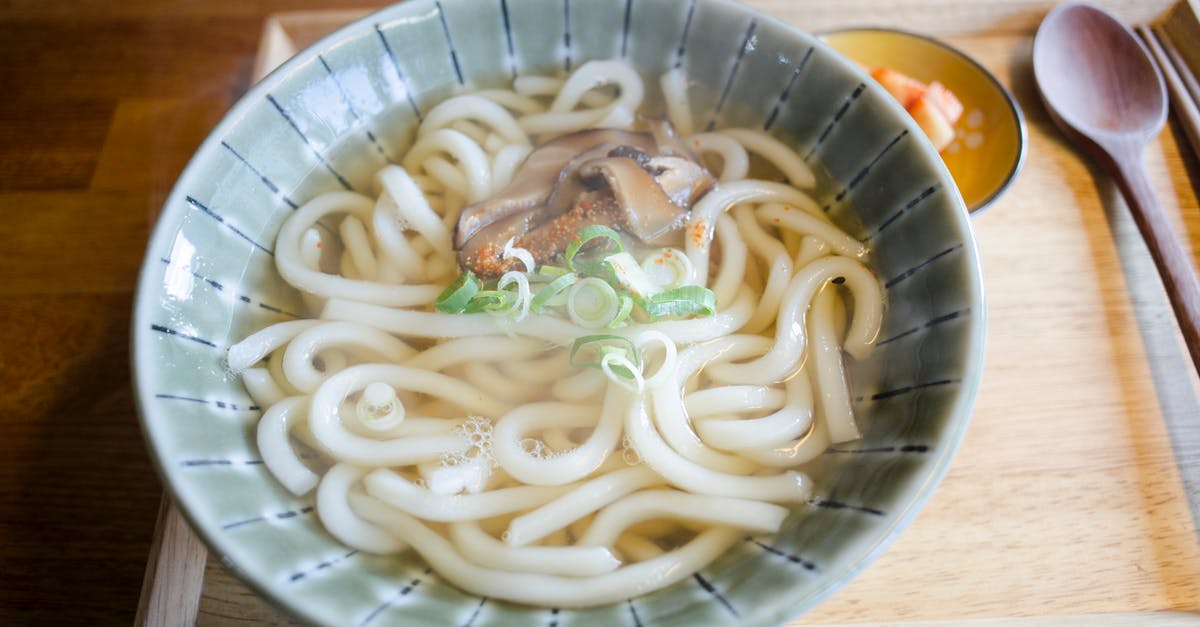 Cooking Ramen noodles in broth or not? - Soup with Pasta and Mushrooms in Ceramic Bowl Cooking Ramen noodles in broth or not? - Soup with Pasta and Mushrooms in Ceramic Bowl