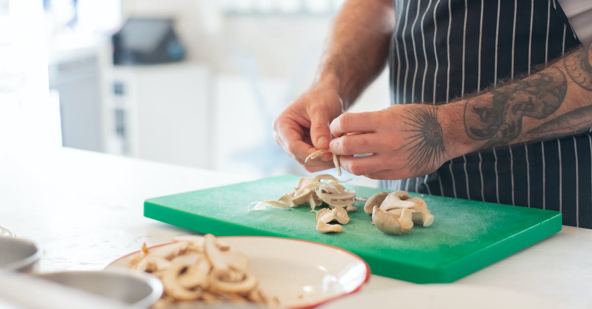 Cooking with a cut or burn on my hands - Man in Striped Apron Peeling Mushrooms on Green Chopping Board Cooking with a cut or burn on my hands - Man in Striped Apron Peeling Mushrooms on Green Chopping Board