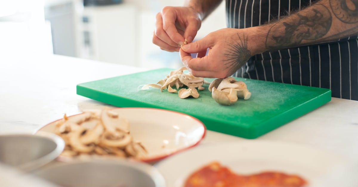 Cooking with a cut or burn on my hands - Man in Apron Peeling Mushrooms Cooking with a cut or burn on my hands - Man in Apron Peeling Mushrooms