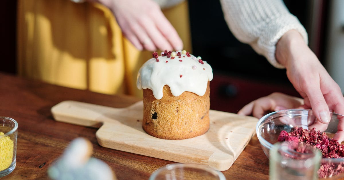 Cooking with ground rabbit - Person Holding Brown Cupcake With White Icing on Brown Wooden Table